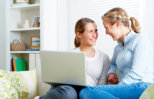 mother and daughter infront of their laptop